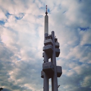 TV tower with large black babies crawling up the side  